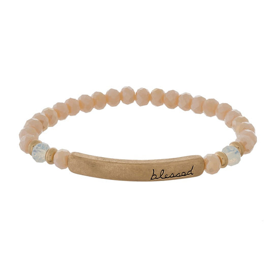 Beaded stretch bracelet with a bar focal, stamped with "blessed" Champagne