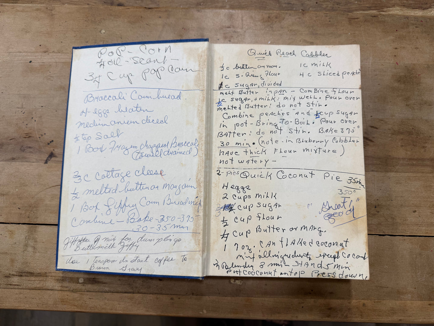 Two handwritten recipe cards on a wooden surface, one titled 'Coconut Noodle Soup' and the other titled 'Coconut Cookie'.
