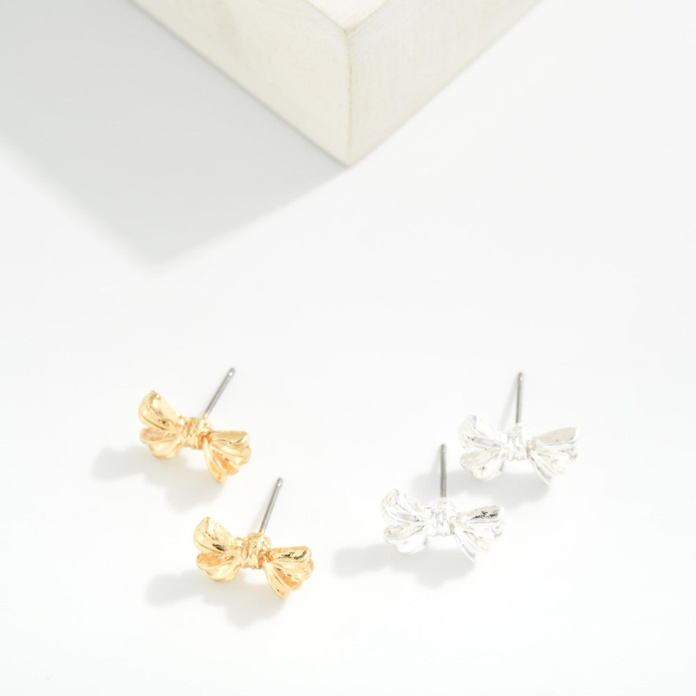 Pair of bow-shaped earrings on a white background
