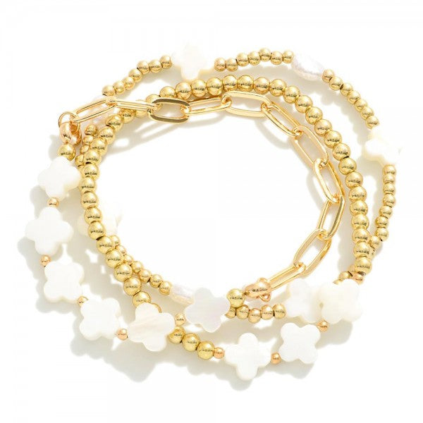 Set of Three Metal Tone Beaded Stretch Bracelets Featuring Mother of Pearl Clovers Chain Link Detail Gold