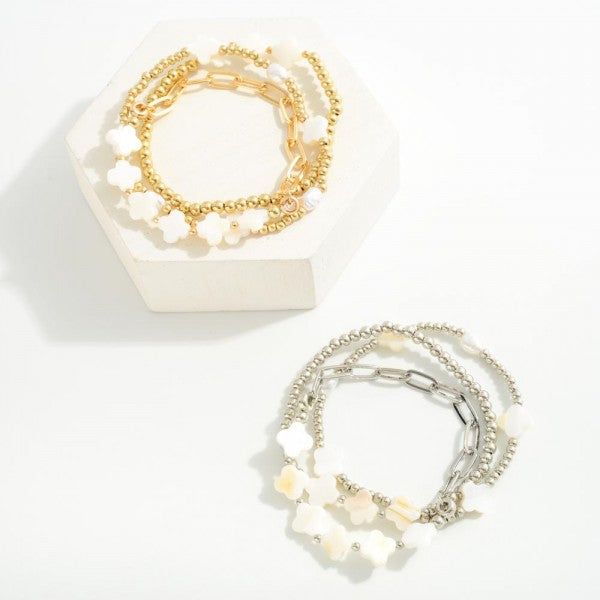 Set of Three Metal Tone Beaded Stretch Bracelets Featuring Mother of Pearl Clovers Chain Link Detail