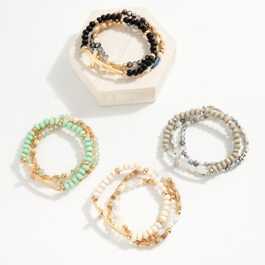 Set Of Three Beaded Stretch Bracelets Featuring Metal Tones, Wood Beads, East West Cross