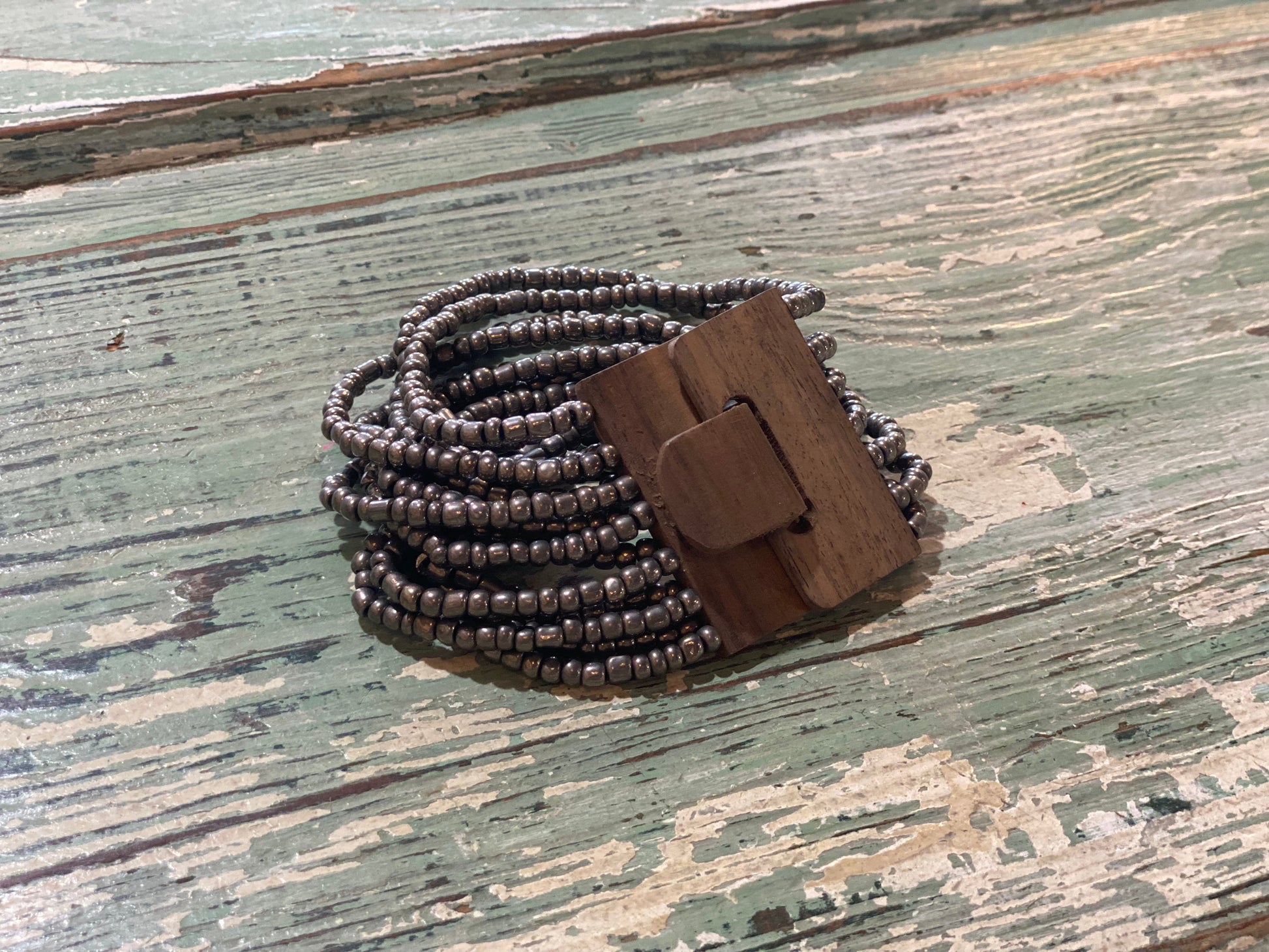 Beaded Strand Bracelet with Wood Clasp Metallic