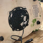 The underside of a vintage wooden appliance, likely a mixer or blender, showing the black motor housing, power cord, mounting feet, and a 'CAUTION' label on a wooden surface.