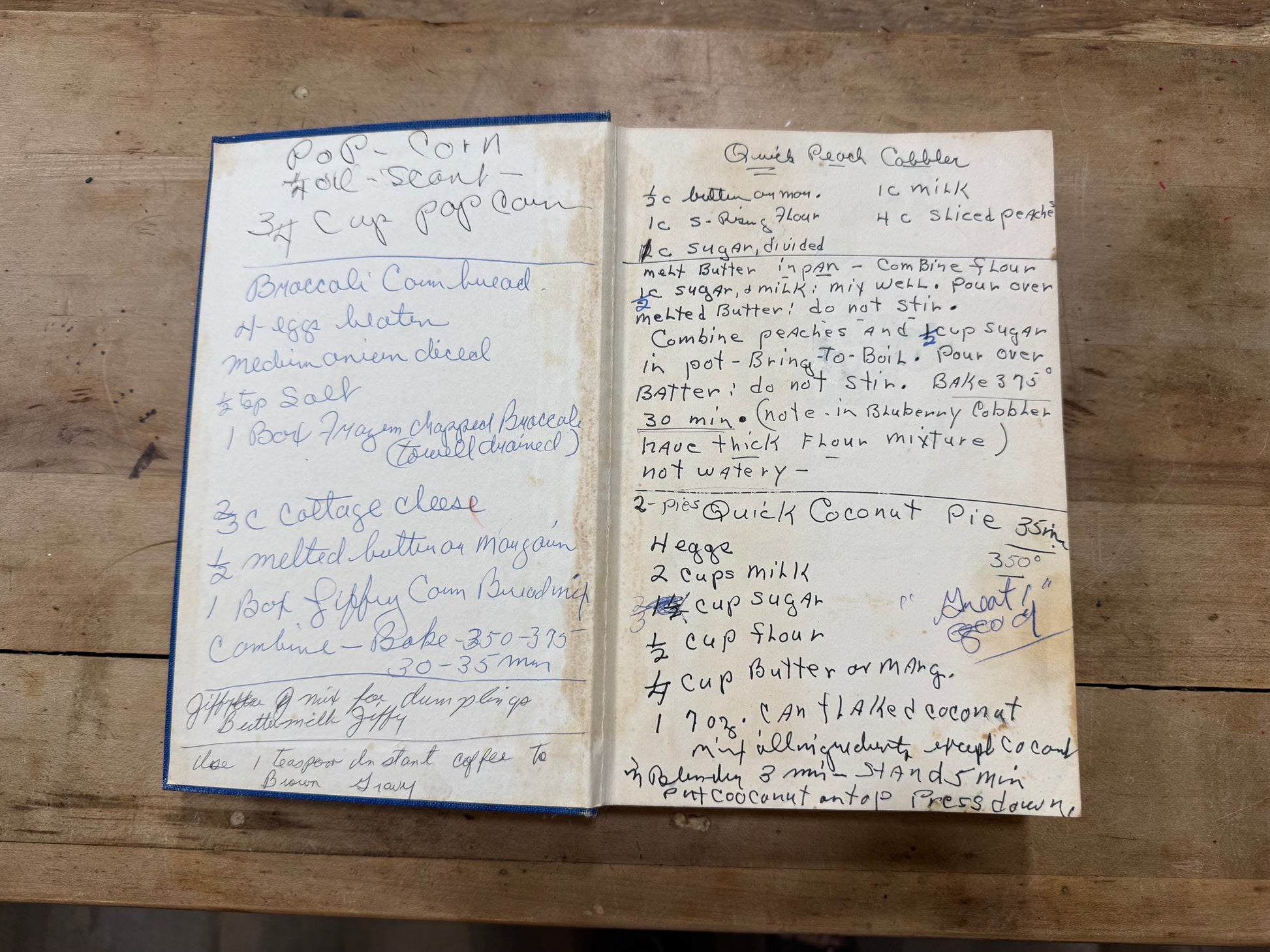 Two handwritten recipe cards on a wooden surface, one titled 'Coconut Noodle Soup' and the other titled 'Coconut Cookie'.