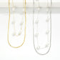 Two Layered Chain Link Necklace Featuring Pearl Stations, one gold and one silver, on a white background.
