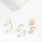 Set of pearl earrings on a light background