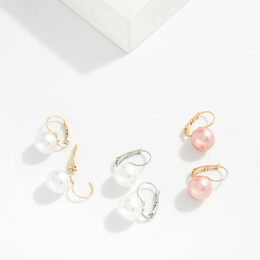 Set of pearl earrings on a light background
