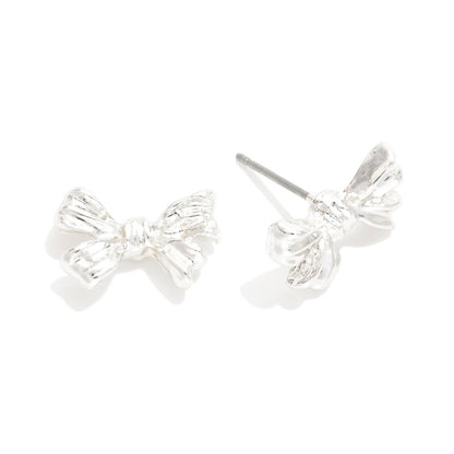 Silver bow-shaped earrings on a white background