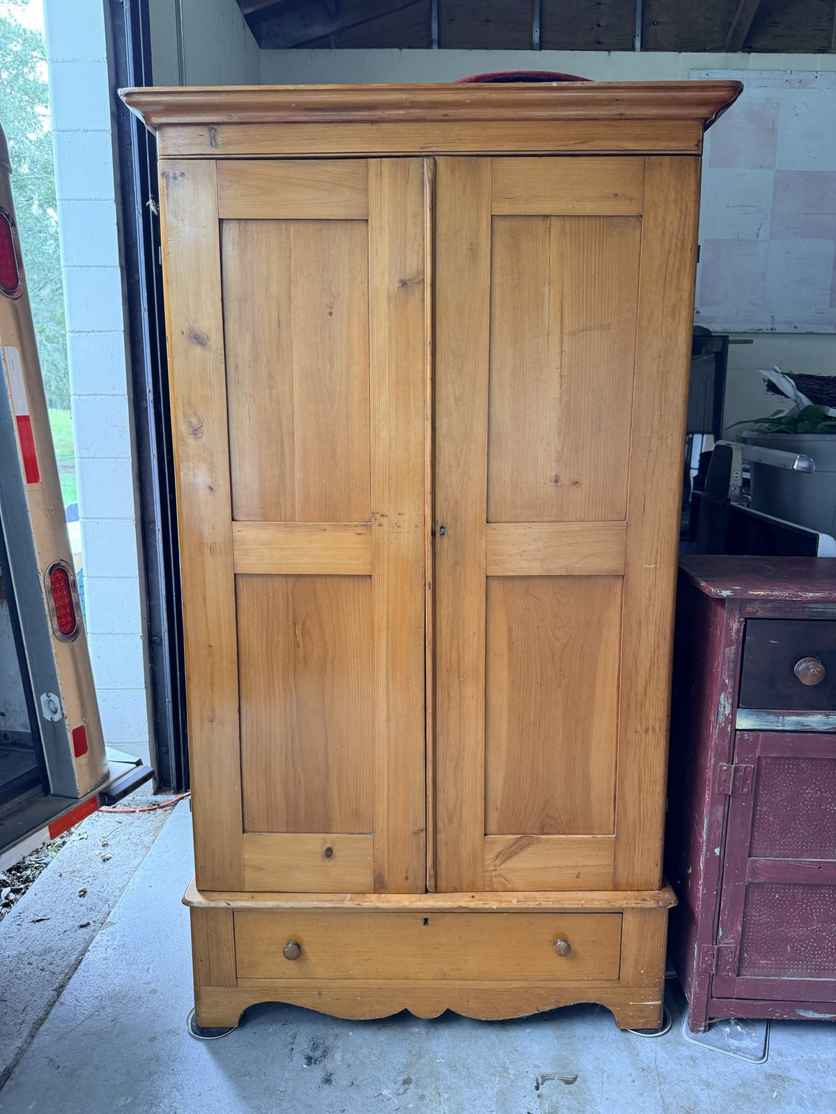 Antique pine two-piece wardrobe armoire, front view with two paneled doors and drawer base