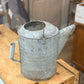 Galvanized Watering Can with dent 