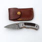 Hand-Forged Damascus Folding Knife | Engraved Bolster, Dark Wood Handle & Intricate Spine File Work - The Mustard Seed Collection, The Seed