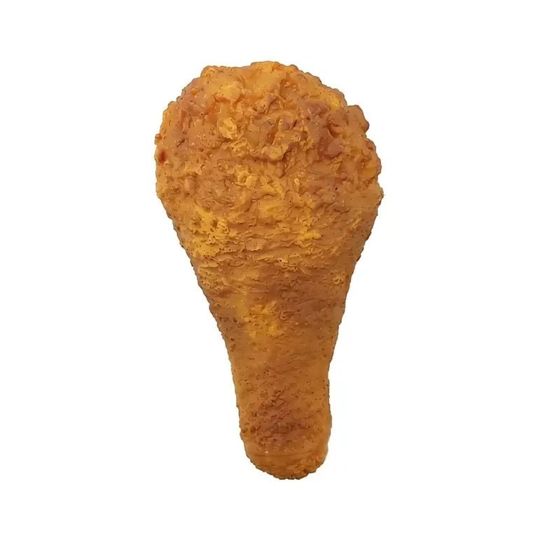 A single golden-brown fried chicken drumstick with a textured, crispy coating, isolated on a solid white background.