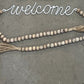 Tassel Tied Garland Welcome Sign - The Mustard Seed Collection, The Seed